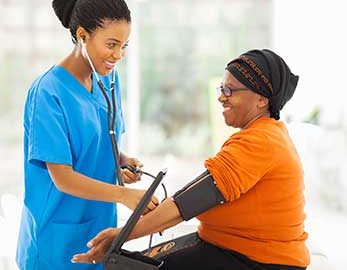 medical assistant taking a patient's blood pressure